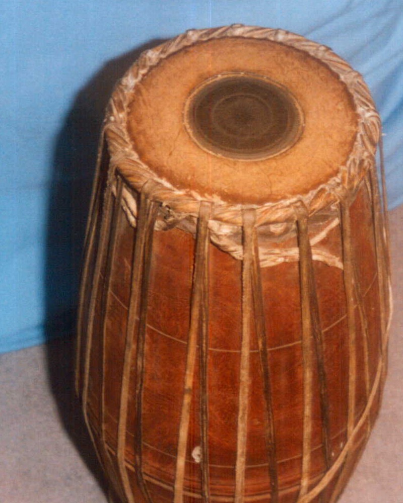Front view of mridangam drum showing right-hand playing surface with black karanai patch in center