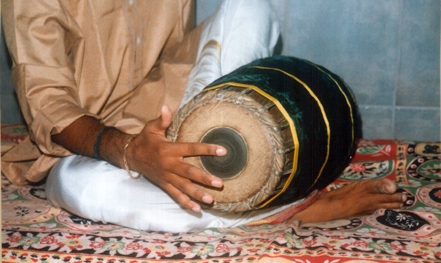 Ta stroke mridangam - index finger striking center of black patch for crisp non-vibrating sound